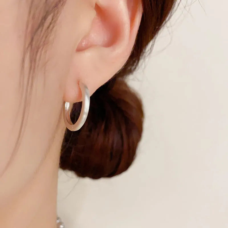 Women's geometric ear clips with round eyelet design in gold plating on copper