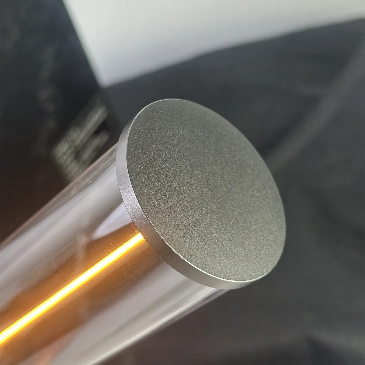 Grey modern LED line glass light strip with magnetic suction base for USB charging.