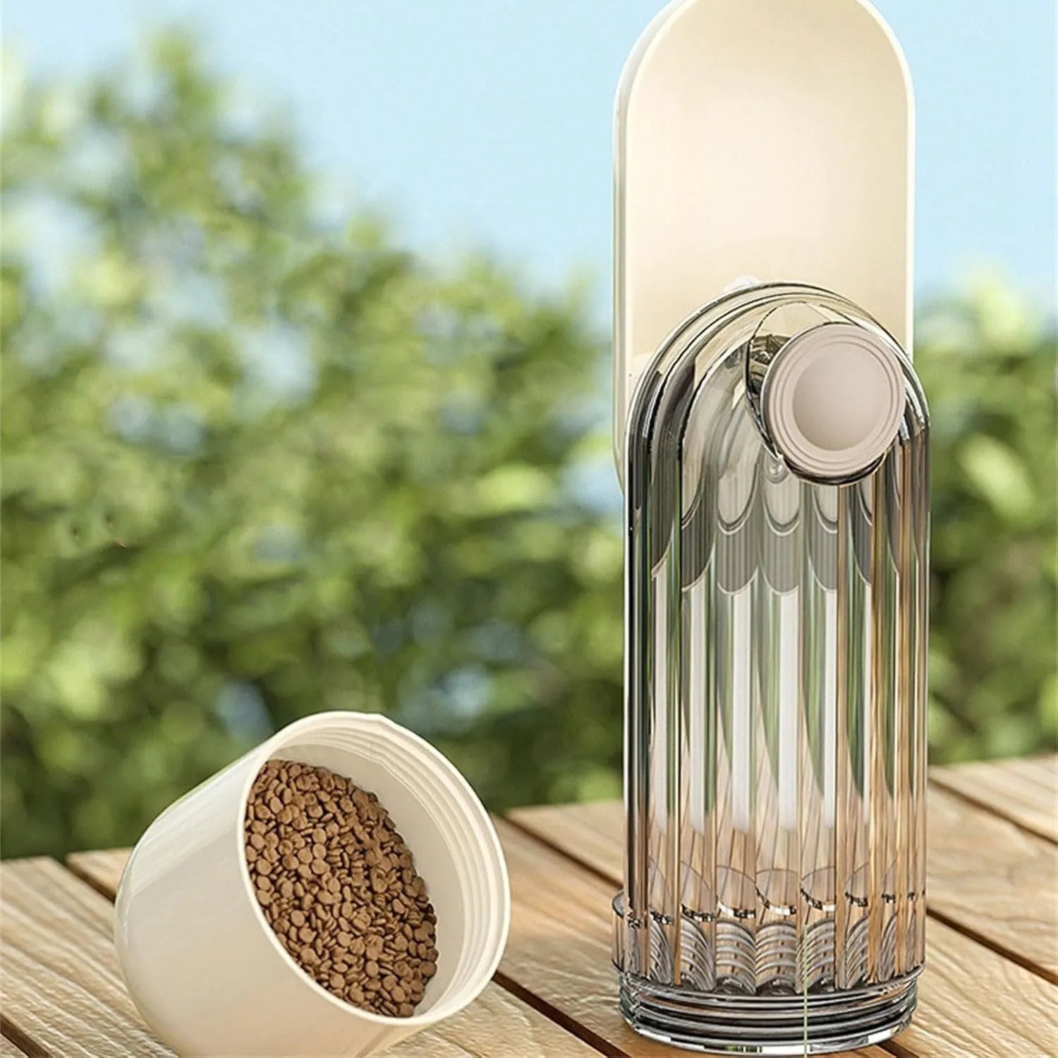 Beige foldable dog water bottle with a press-button dispenser and a small food container at the base.