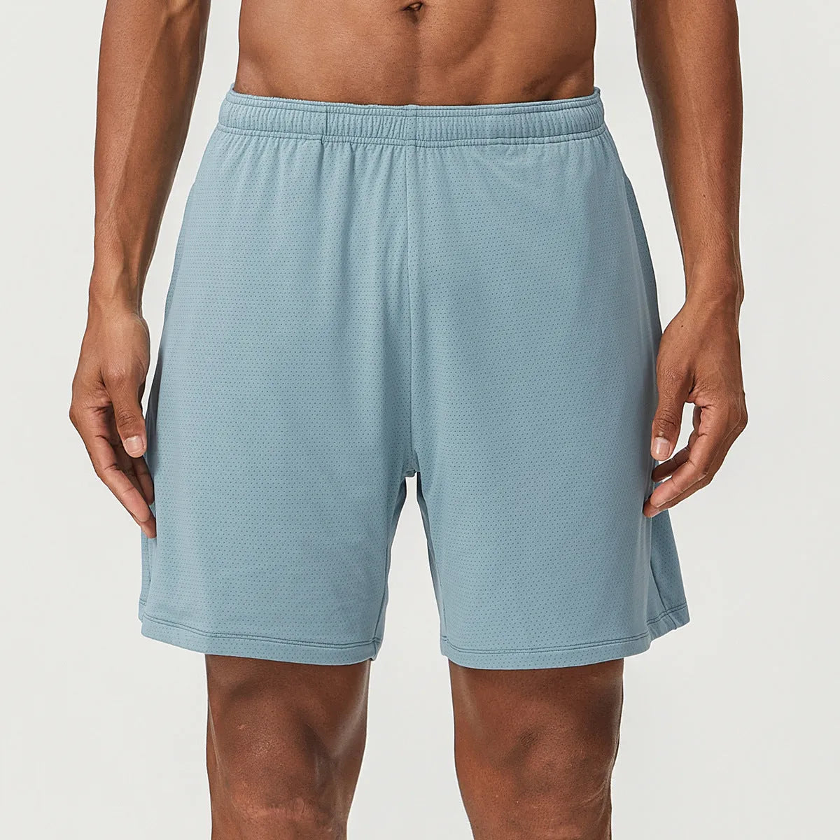 Men's double-layer running shorts in sky green, showing mid-waist fit and shorts length.