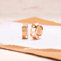 Rose gold women's earrings with a hollow heart shape and circular silhouette.