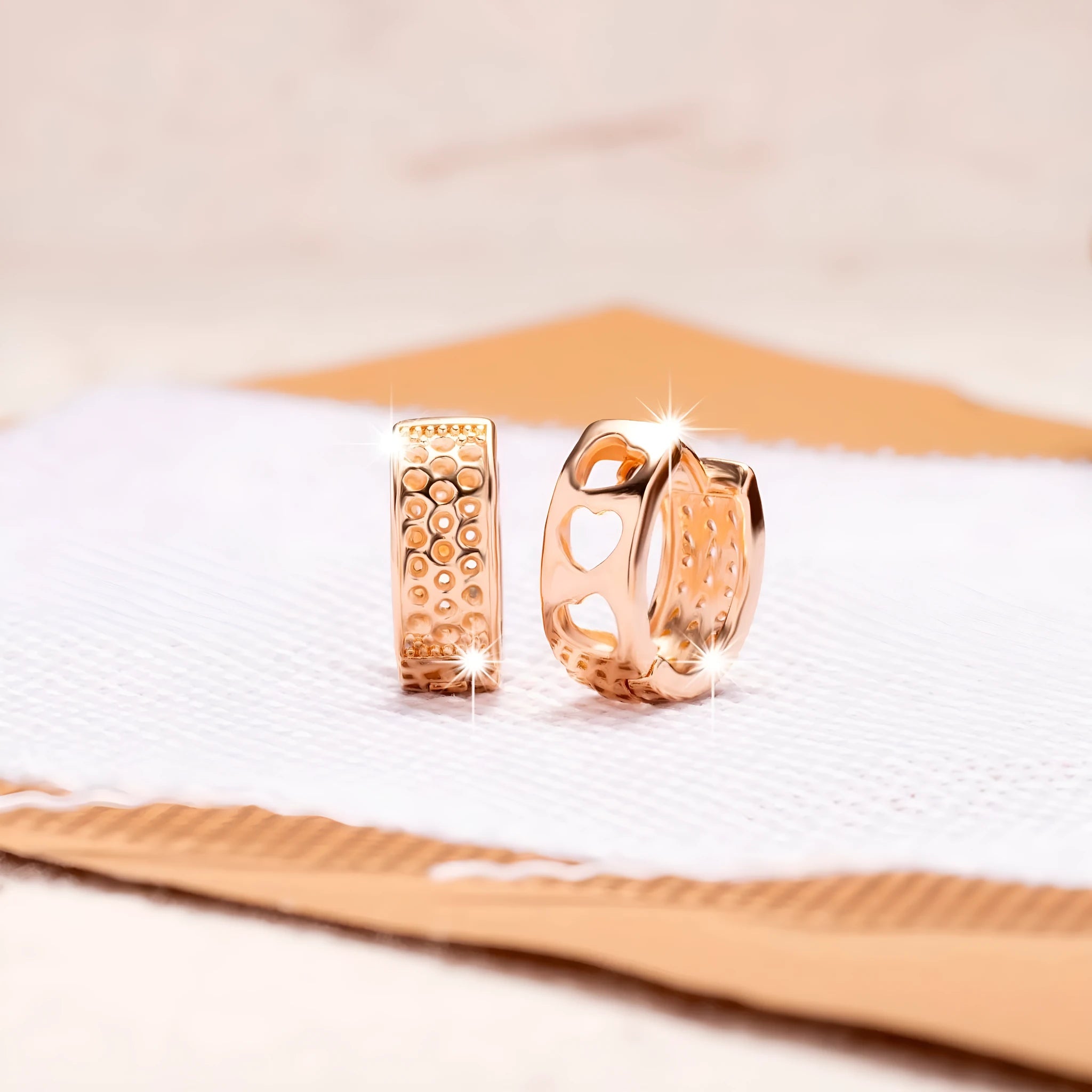 Rose gold women's earrings with a hollow heart shape and circular silhouette.