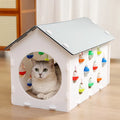 Plastic cat scratch board integrated with cosy nest and tunnel containing bell ball
