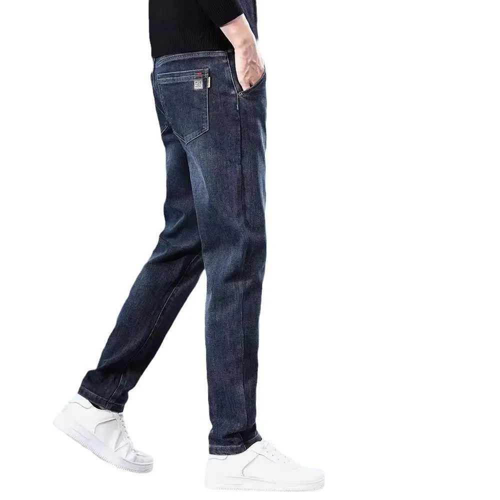 Man wearing slim straight blue grey casual trousers with a loose thin fit and zip fly.