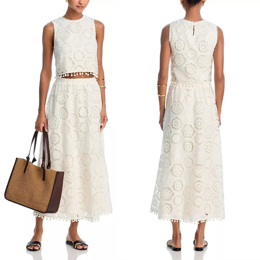 White women's two-piece suit with sleeveless top, long skirt, and embroidery detail.