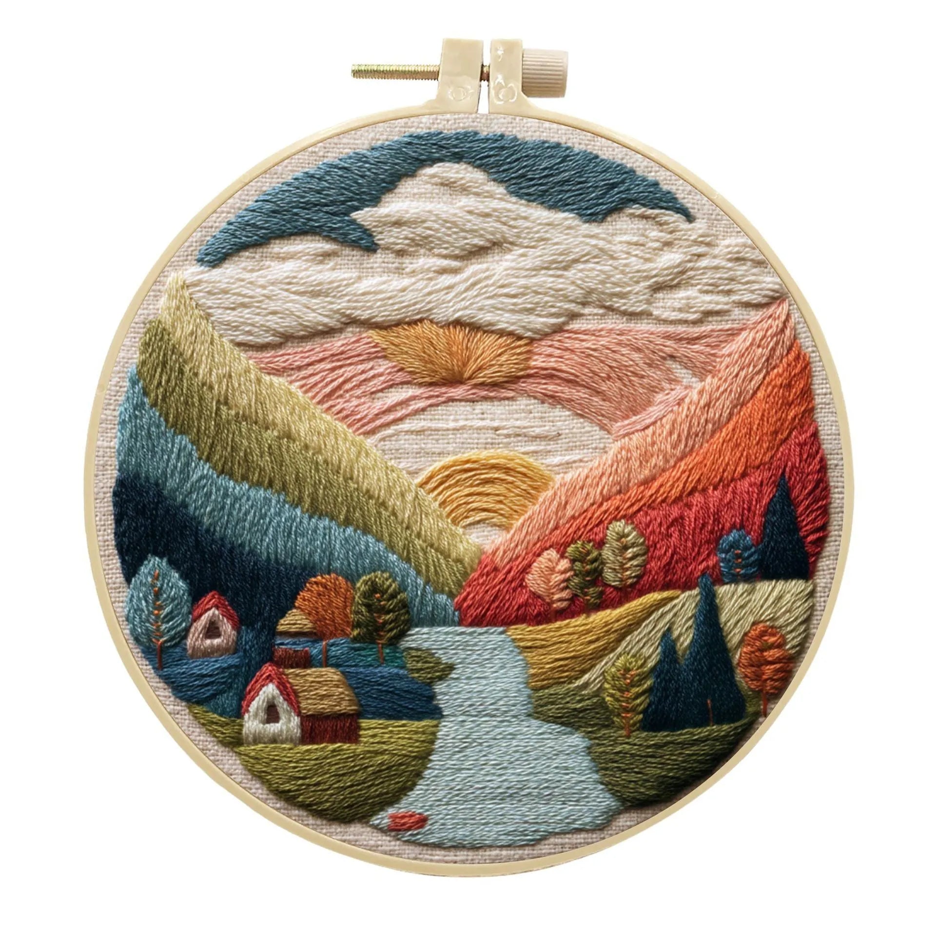 DIY embroidery kit with landscape-printed cotton fabric, embroidery hoop, needles, and coloured thread spools.