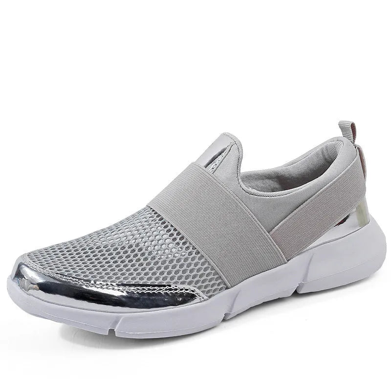 Women's blue, black, and grey lightweight mesh low-top sneakers on a hard floor.