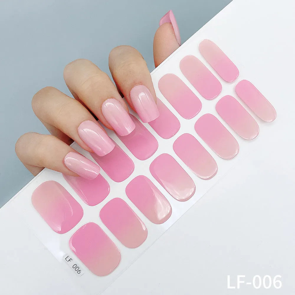 Set of 16 solid colour nail art stickers showing floral, geometric, and pattern designs for manicure application