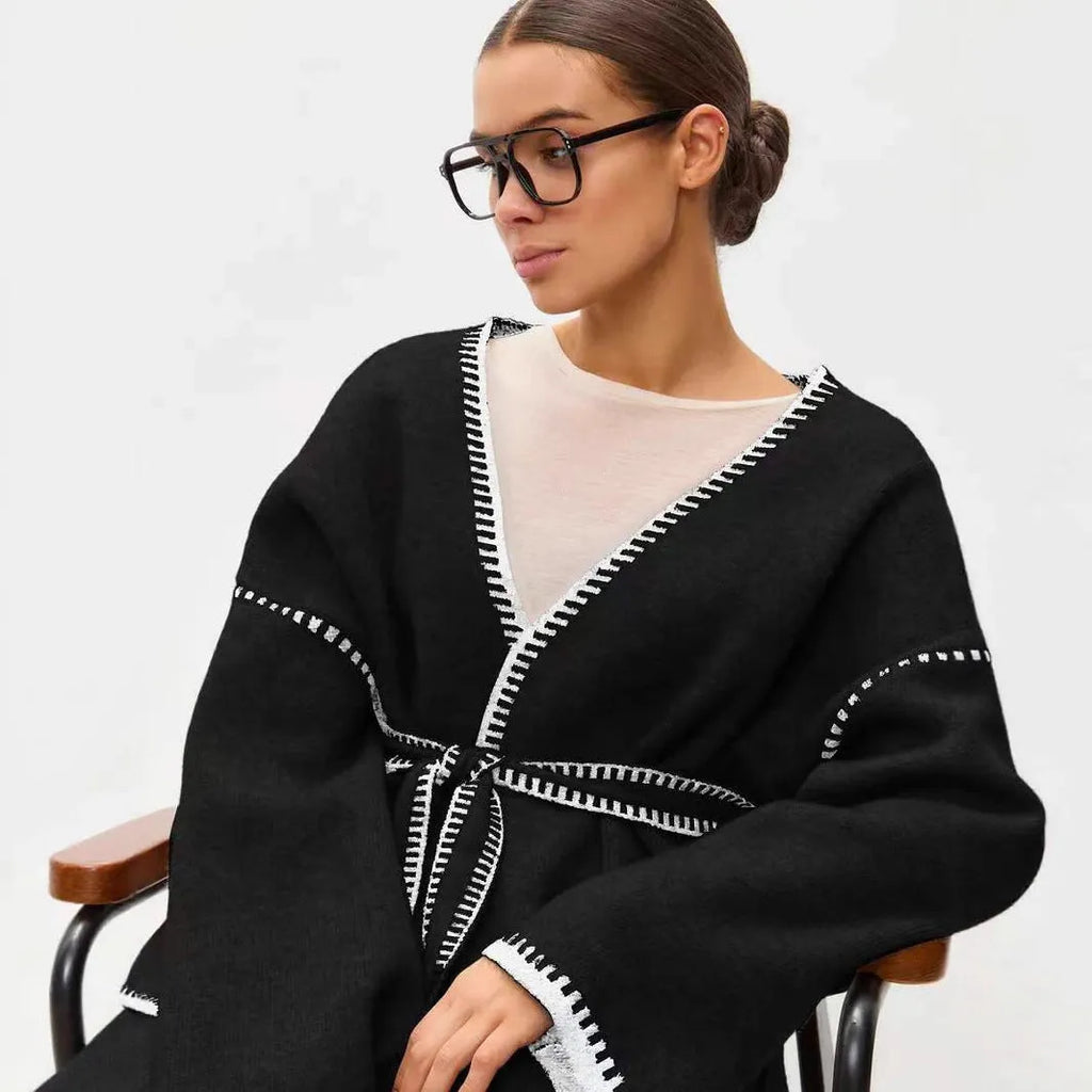 Lace-up front knitted cardigan sweater coat in camel colour, showing loose fit and long sleeves.