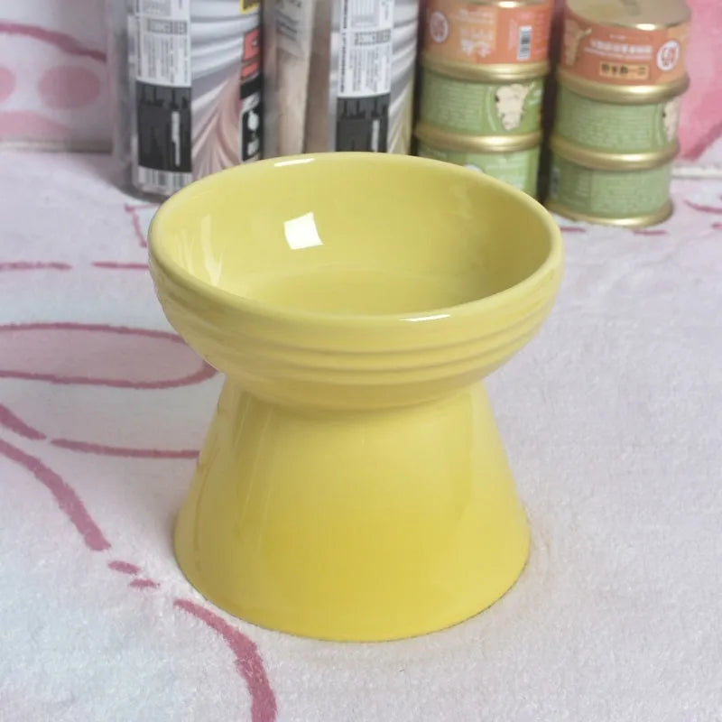 Black ceramic pet bowl with a chin-high foot and raised neck protector on a white background.
