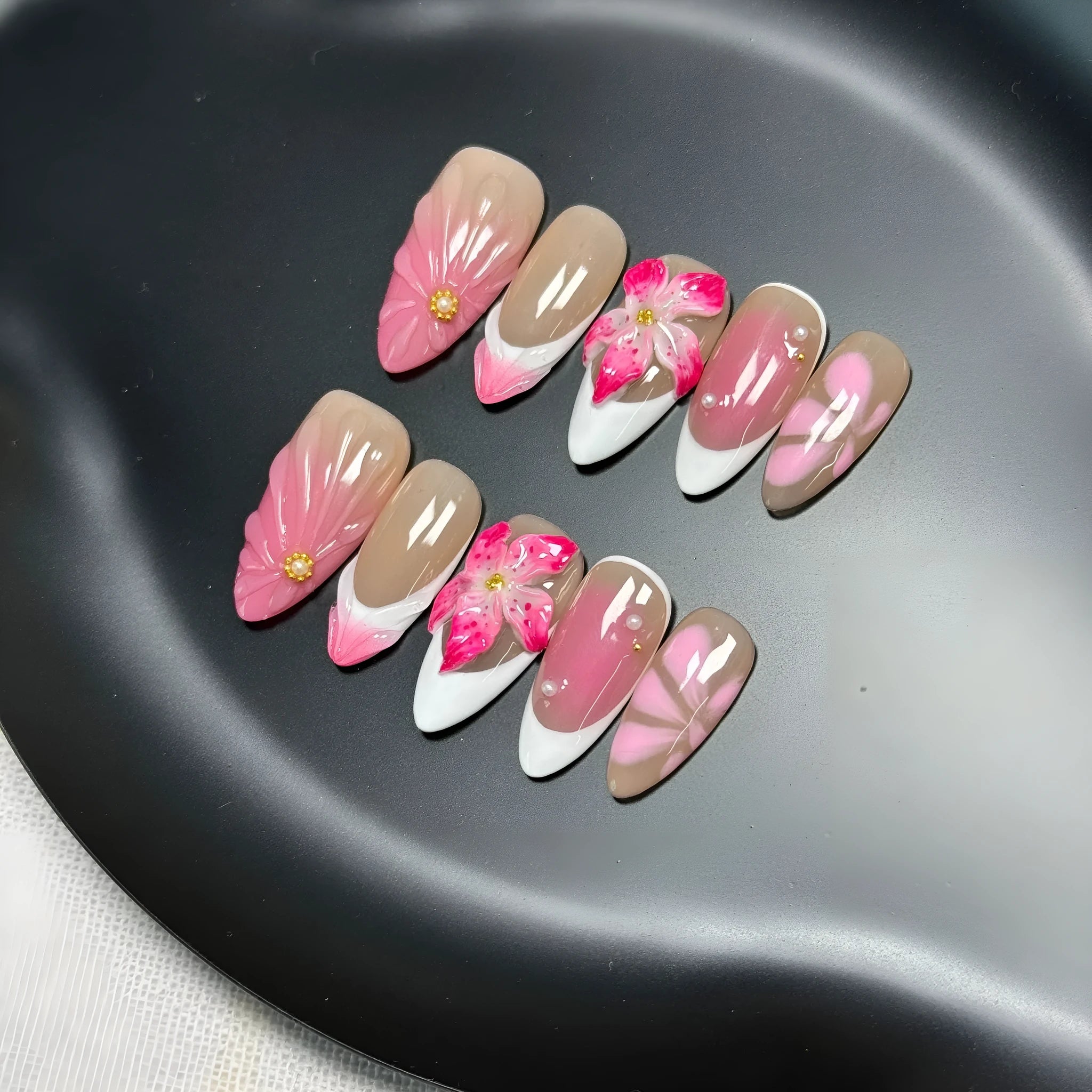 French style three-dimensional lily ice flower gel nail stickers in almond shape on plastic backing.