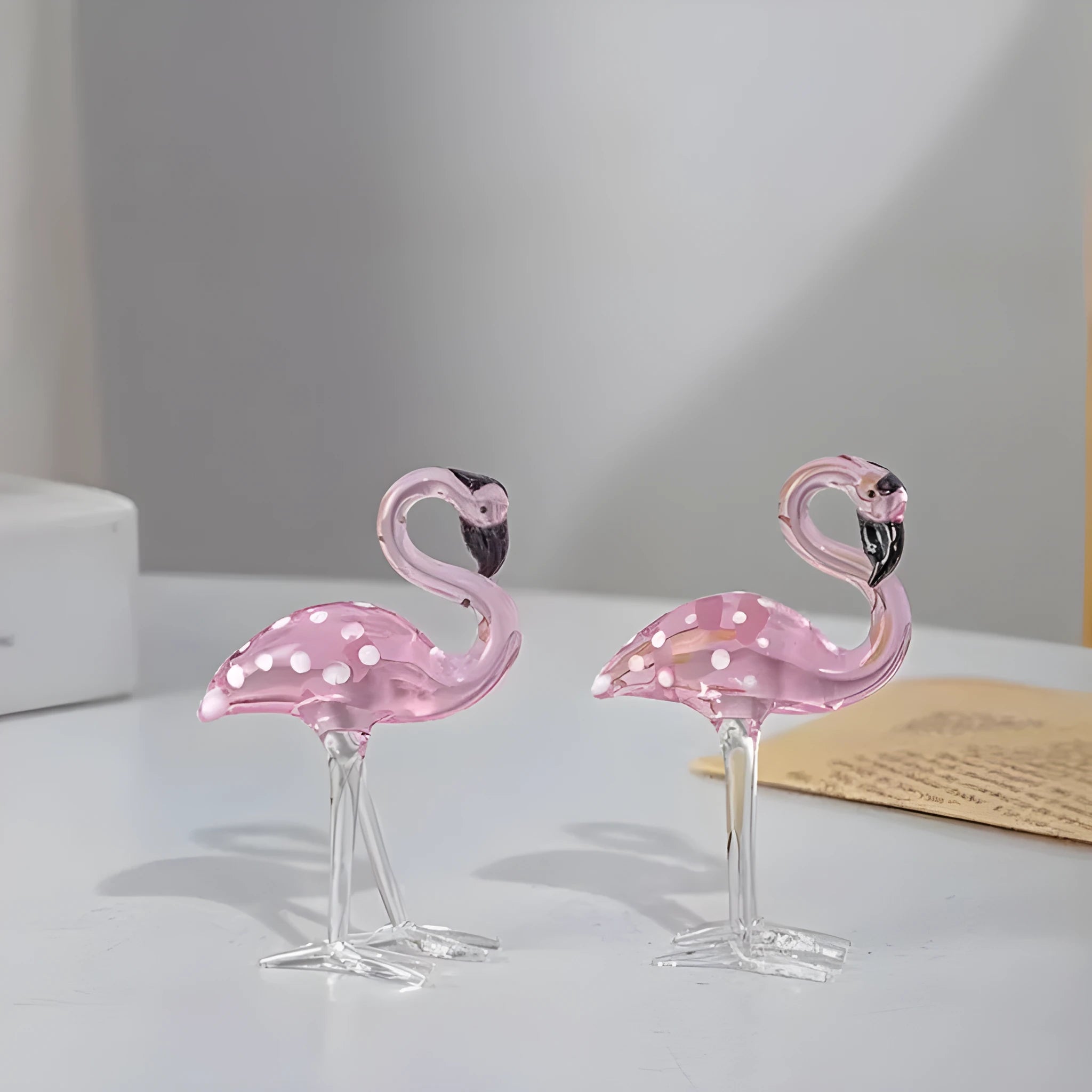 Pink crystal flamingo decorative sculpture on table with modern minimalist design