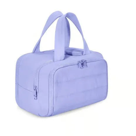Large lightweight travel toiletry bag in beige with wide open design showing fluffy interior