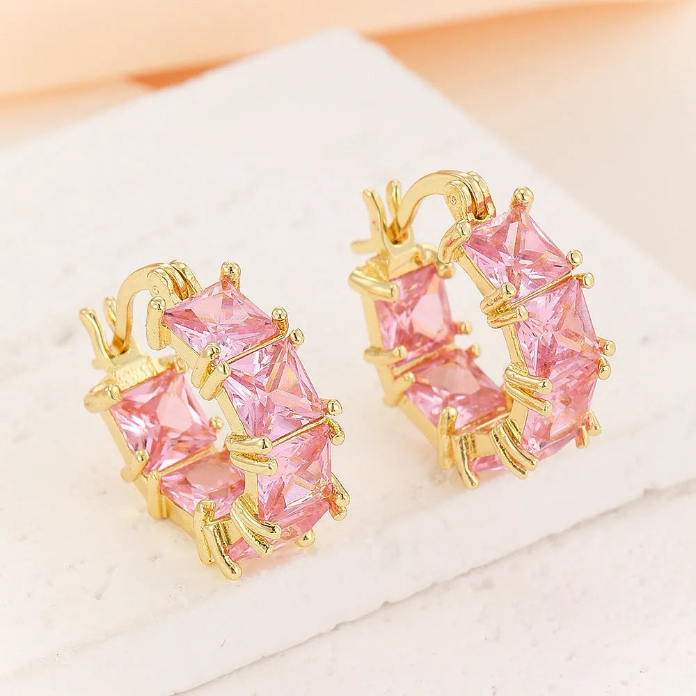 Gold geometric U-shaped women's earrings with a round black zircon stone.