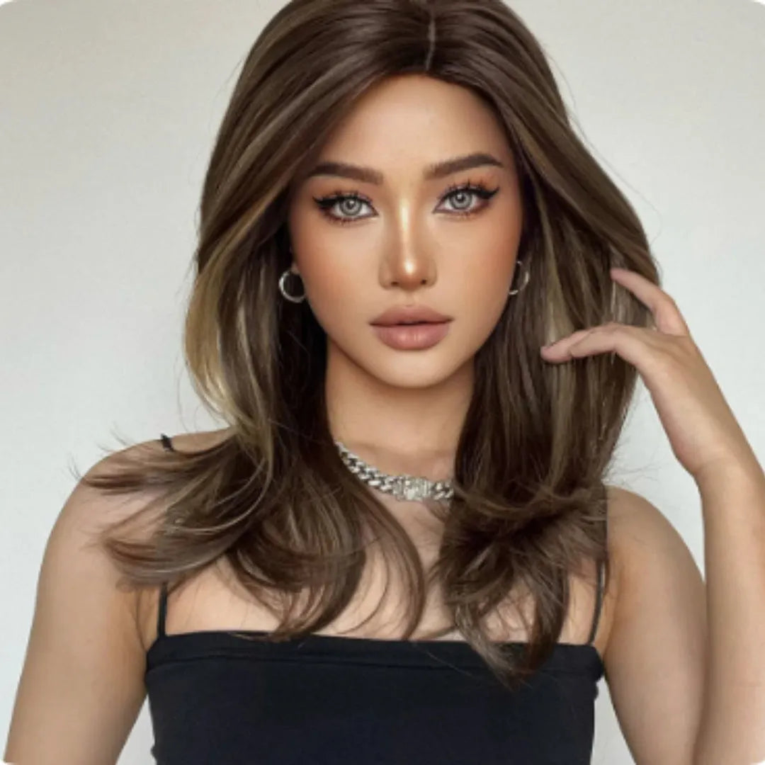 Mid-length curly full-head synthetic wig with long bangs in a platinum gradient colour.