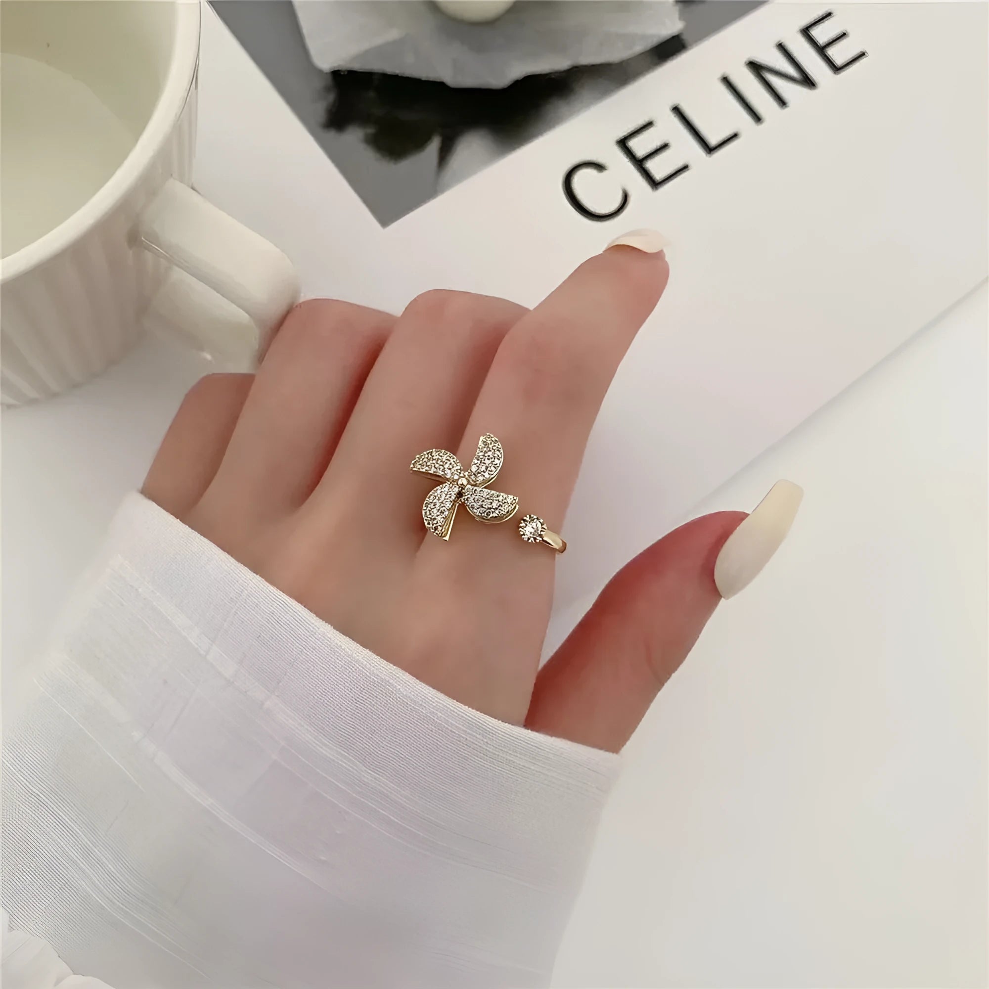 Gold electroplated copper ring with rotating windmill design and micro inlaid geometric detailing