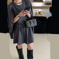 Women's black knitted polyester vest skirt and long sleeve cardigan two-piece set with a belt.