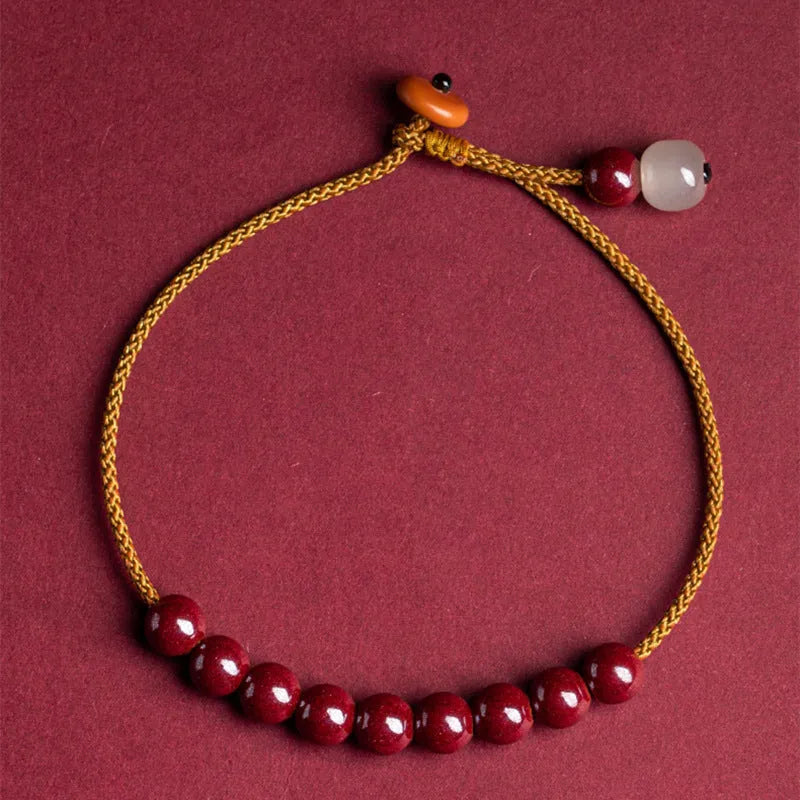 Hand-woven raw ore cinnabar bracelet with Hetian jade accents in a geometric design.