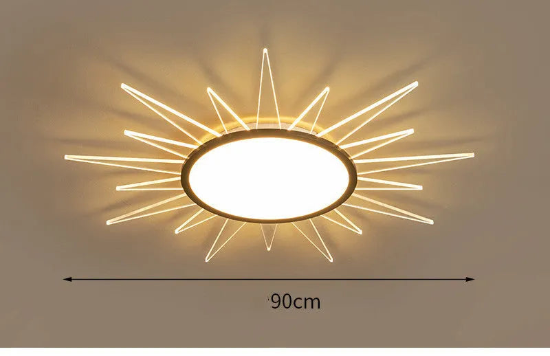 Modern round aluminium LED ceiling lamp with a white shade on a ceiling.