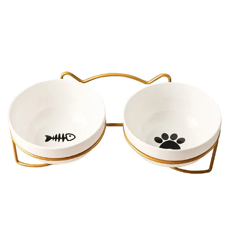 White ceramic cat bowl with decorative pattern sitting in a black iron frame stand.