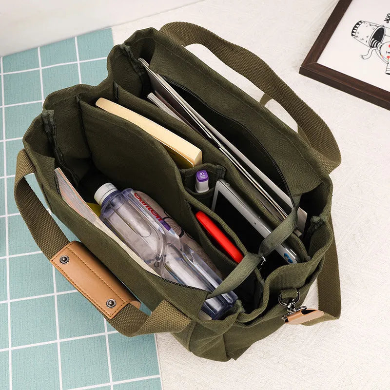 Large khaki canvas tote bag for women with open top showing internal laptop and camera pockets