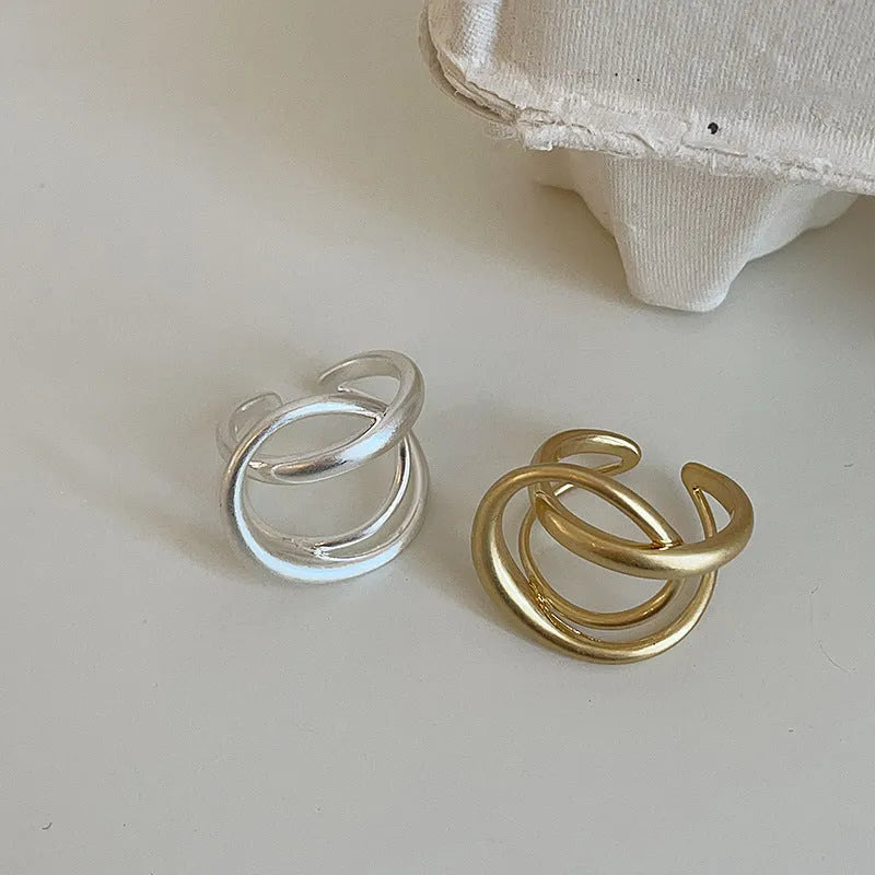 Geometric open ring with three-dimensional interlaced matte metal design in gold or silver electroplated finish