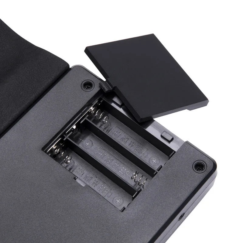 Gloss black portable folding electronic keyboard with 49 silicone keys, unfolded next to its compact folded size.