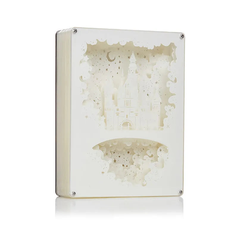 Bedside night light with paper carving design and remote control on wooden nightstand
