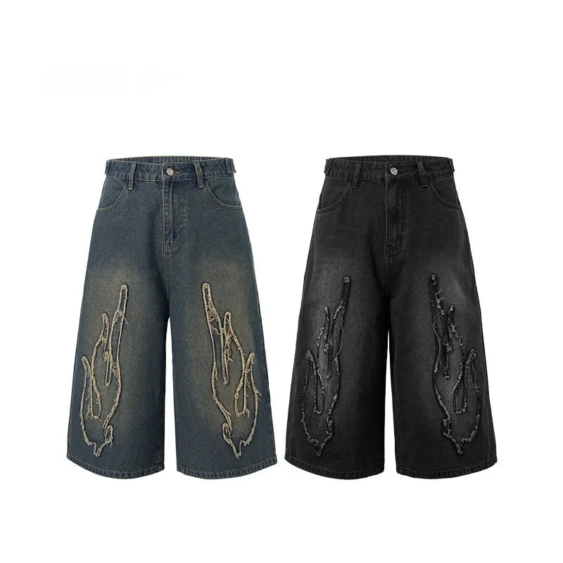 Men's black denim shorts with flame embroidery patch detail, cropped length and straight leg street style