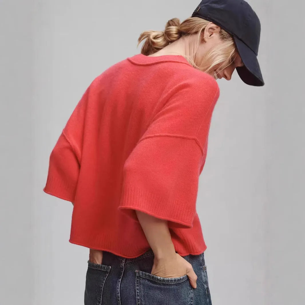 Red women's crop top t-shirt with regular sleeves on a hanger.