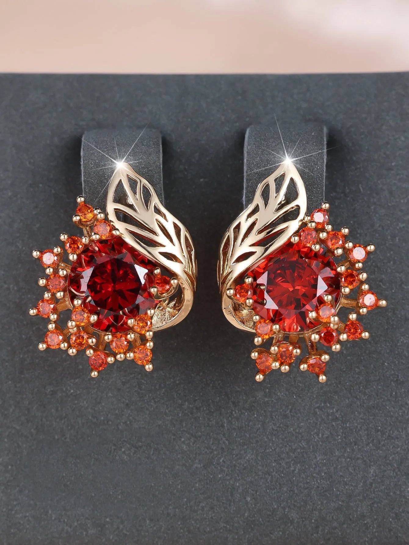 Round floral earrings with feather detailing and coloured zircon stones in champagne gold finish
