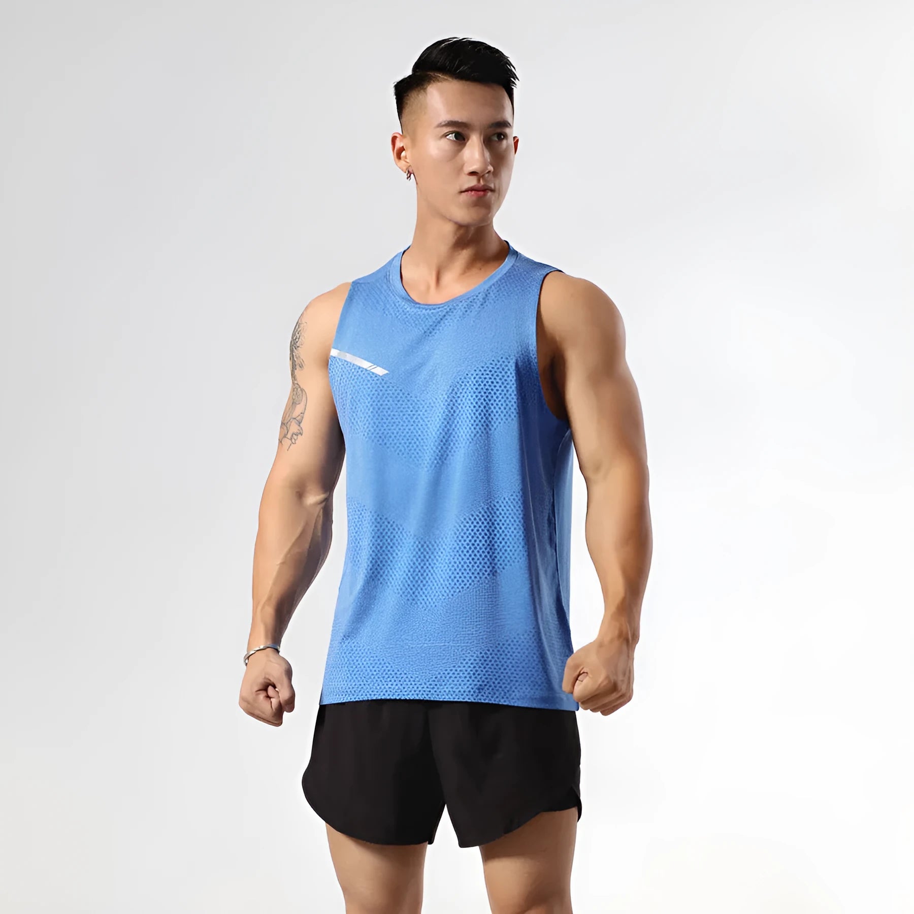 Man wearing a grey quick-drying polyester sports tank top for summer outdoor activities.
