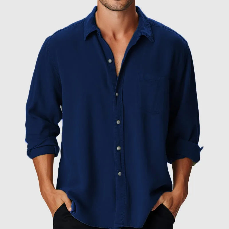 Man wearing a loose-fit long sleeve casual shirt with a stand collar, suitable for beach holidays.