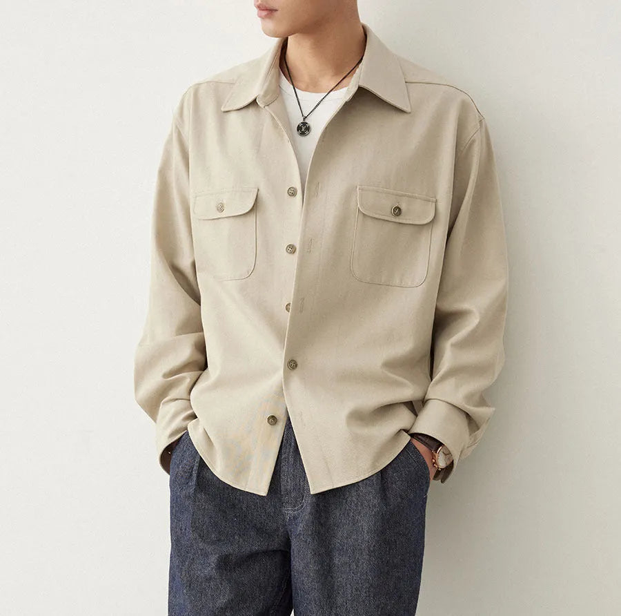 Men's simple lapel long sleeve shirt in light sand rice colour, cotton blend fabric, laid flat.
