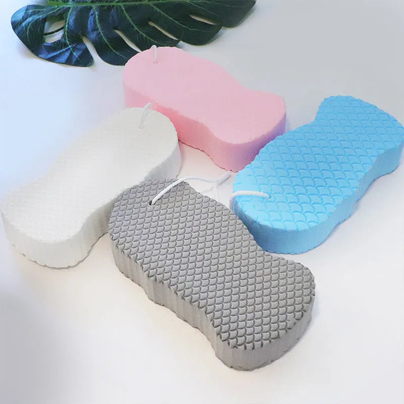 White 3D fish scale pattern bath sponge ball on a bathroom surface