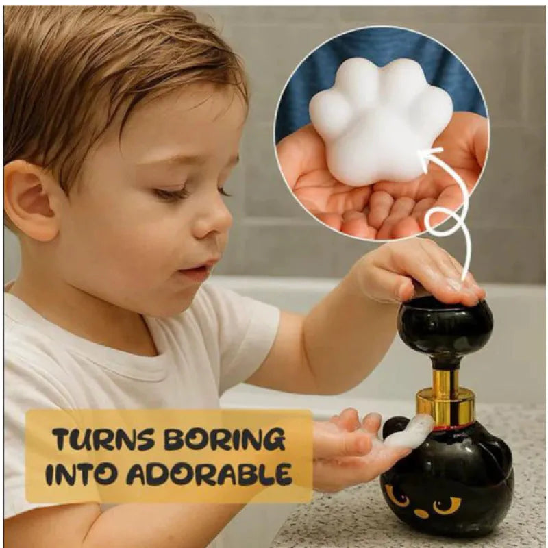 Black cartoon cat-shaped automatic foam soap dispenser on a countertop.