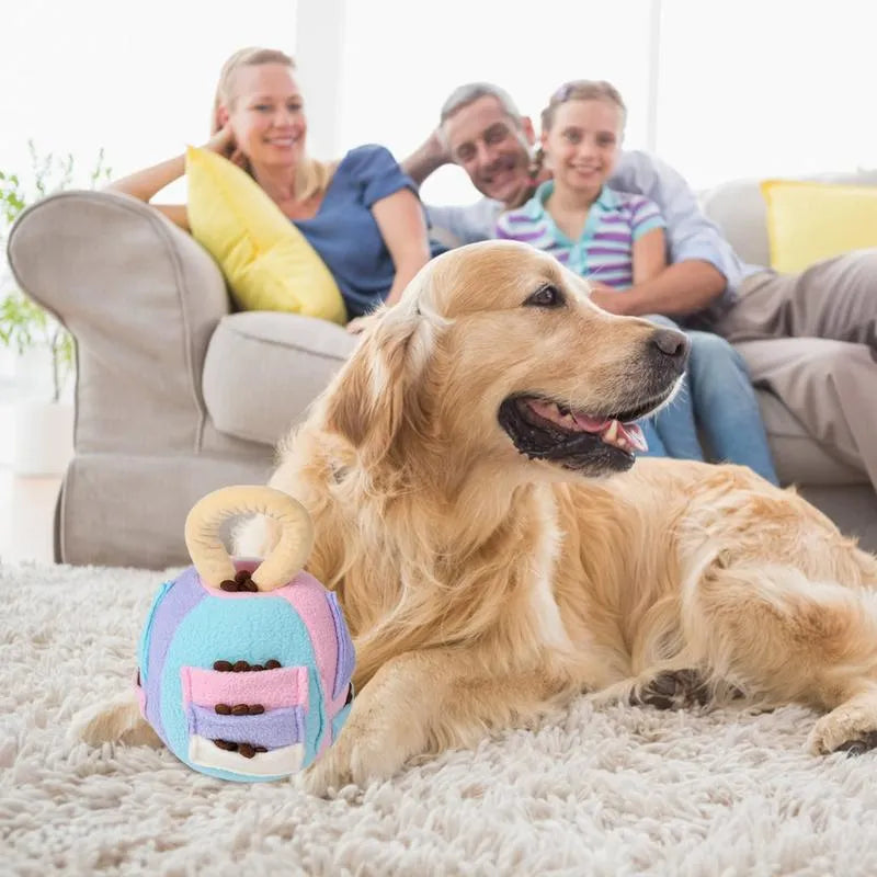 Green or pink polyester plush ball dog toy with treat pockets and a squeaker, shown next to dog treats.
