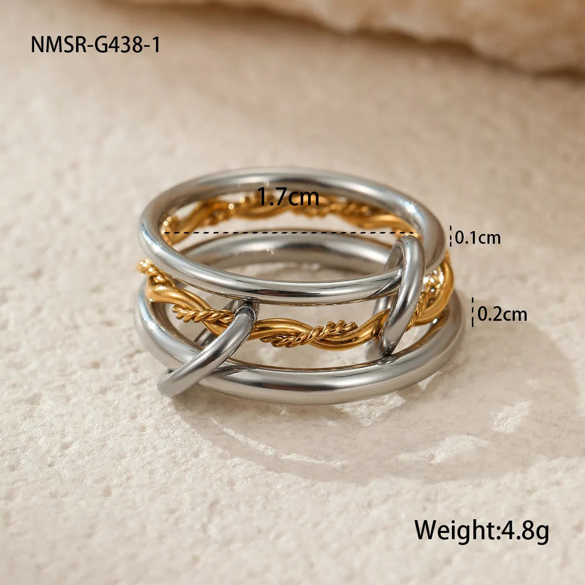 Stacked gold plated stainless steel ring set with exaggerated design on hand