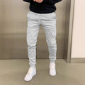 Men's loose polyester trousers with patch pockets and elastic waistband in light blue colour