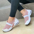 Women's flat sneakers in light grey with mesh upper, round toe, and rubber sole.