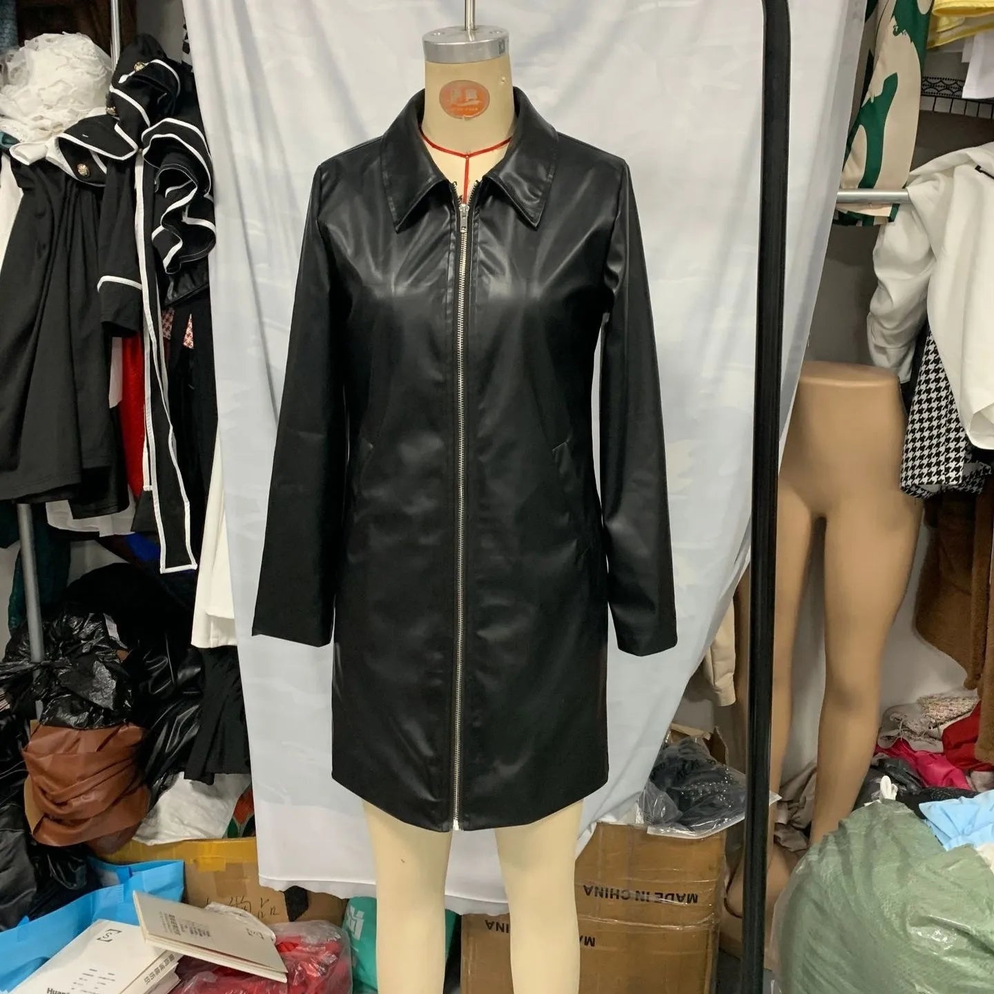 Women's black leather-style jacket with a medium 65cm length and long sleeves.