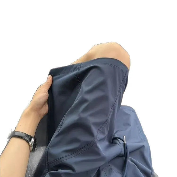 Men's quick-drying sports shorts in polyester with elastic waistband, shown in creamy-white colour
