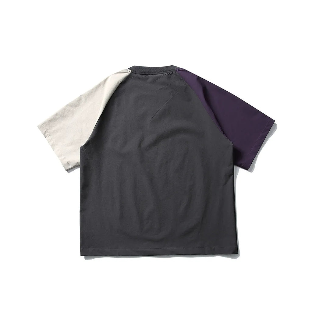 Dark grey loose-fit t-shirt with contrast colour raglan short sleeves on a hanger.