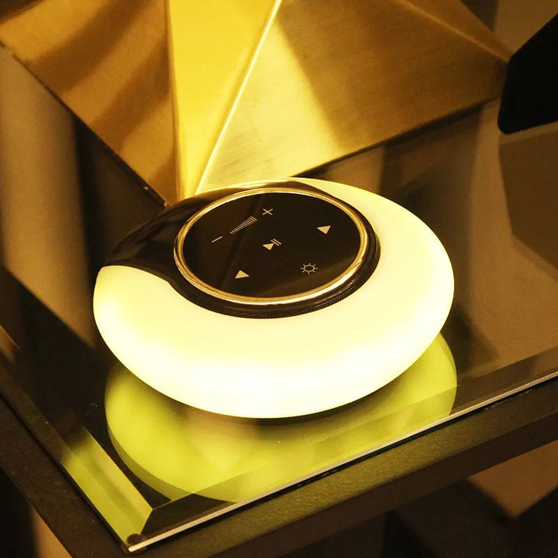 Blue Bluetooth speaker LED desk lamp with touch controls and folding design on wooden desktop