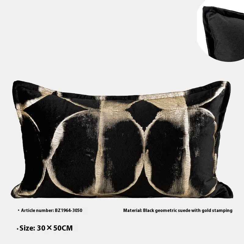 Black and gold abstract patterned flannel cushion on a sofa, showing removable cover.