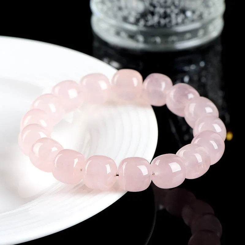 Pink crystal barrel bead bracelet with geometric design for men and women.