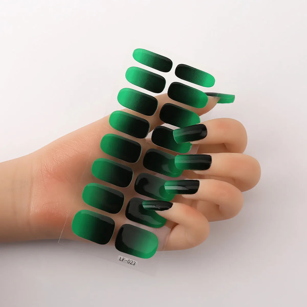 Set of 16 solid colour nail art stickers showing floral, geometric, and pattern designs for manicure application