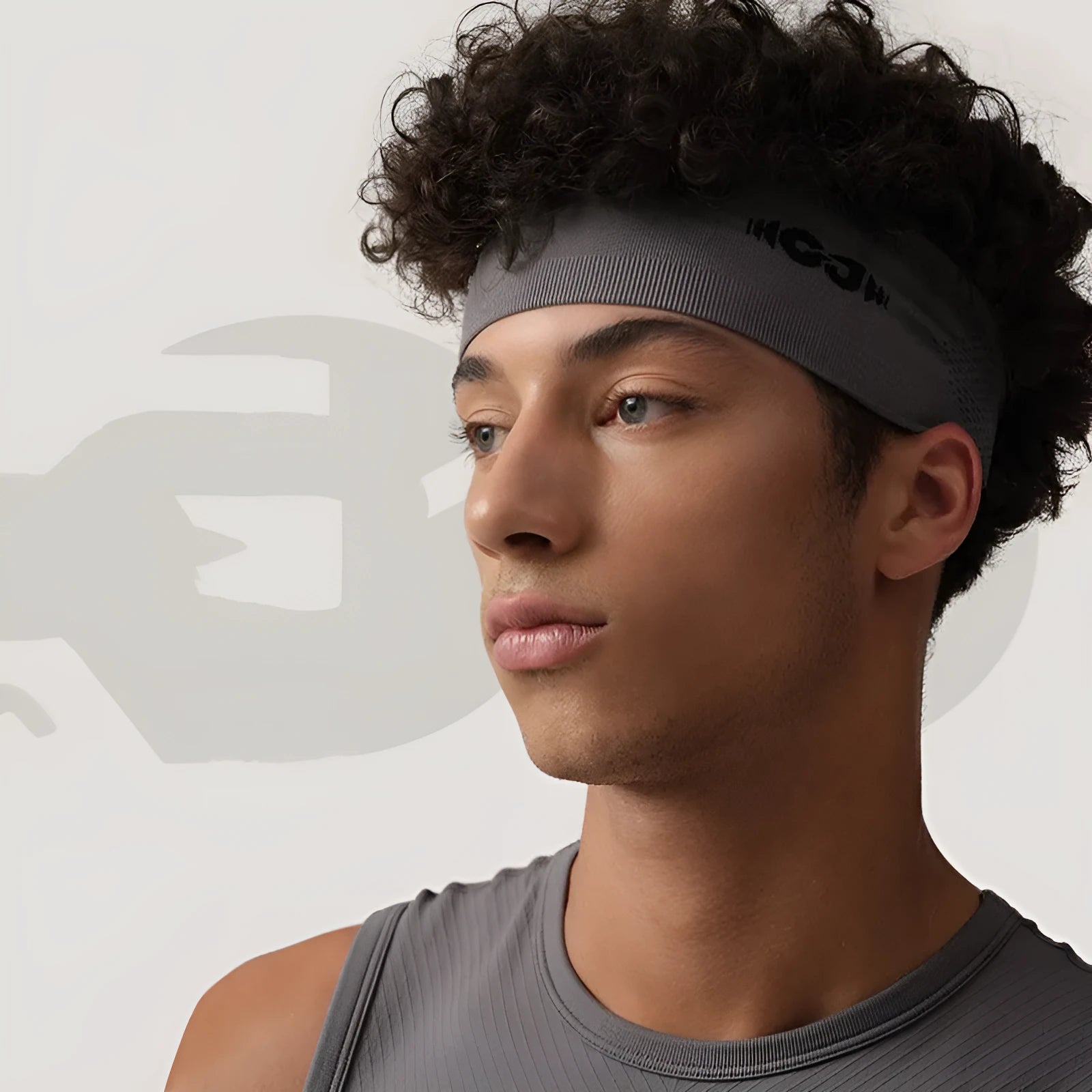 Seamless knitted exercise hair band in classic black shown stretched slightly to demonstrate elasticity