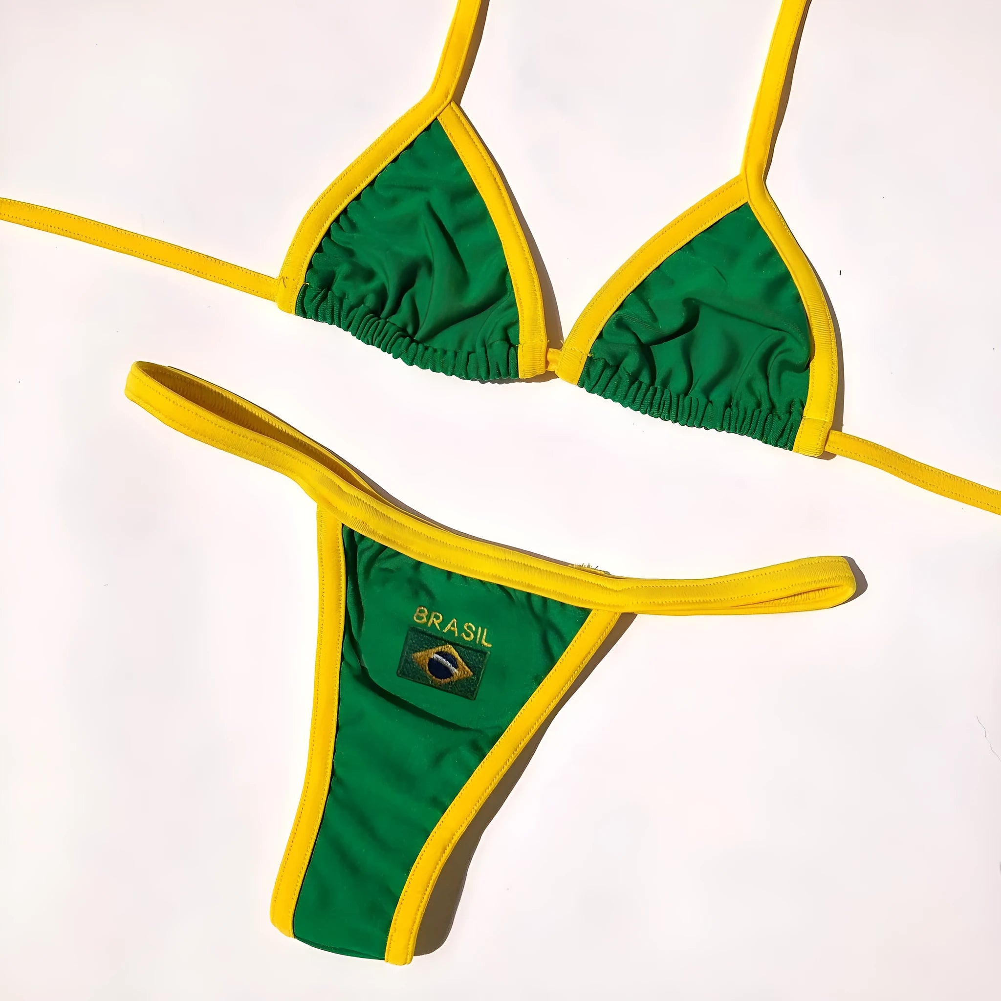Women's blue polyester bikini set with T-back bra and shorts-length panties on a neutral background.