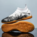 Men's black and yellow football boots with removable rubber studs on artificial grass